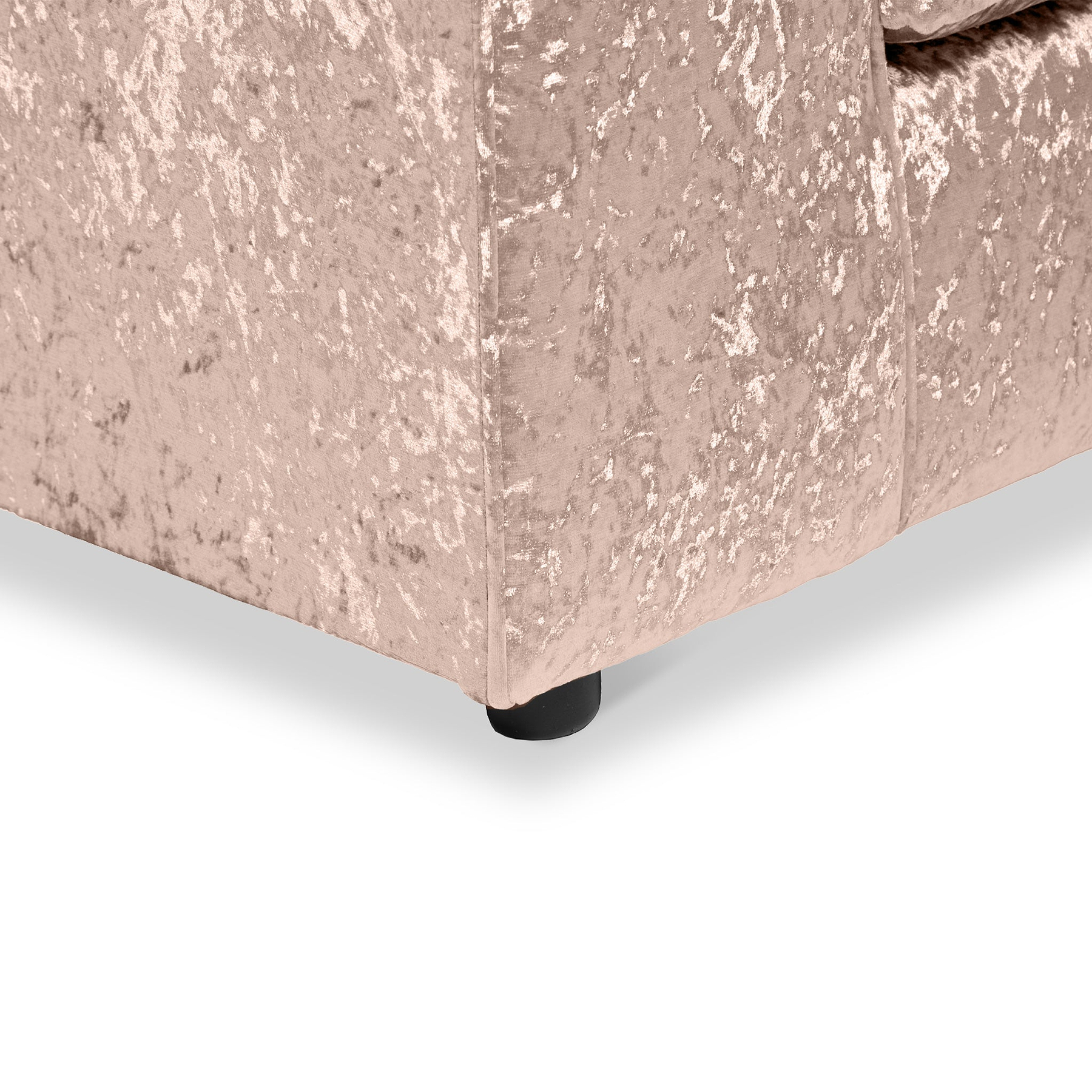 A portion of a light pink, plush-textured sofa with visible corner and black round leg set against a plain white background.