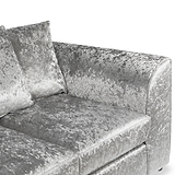 A plush grey crushed velvet loveseat with two cushions, resting against an isolated white background.