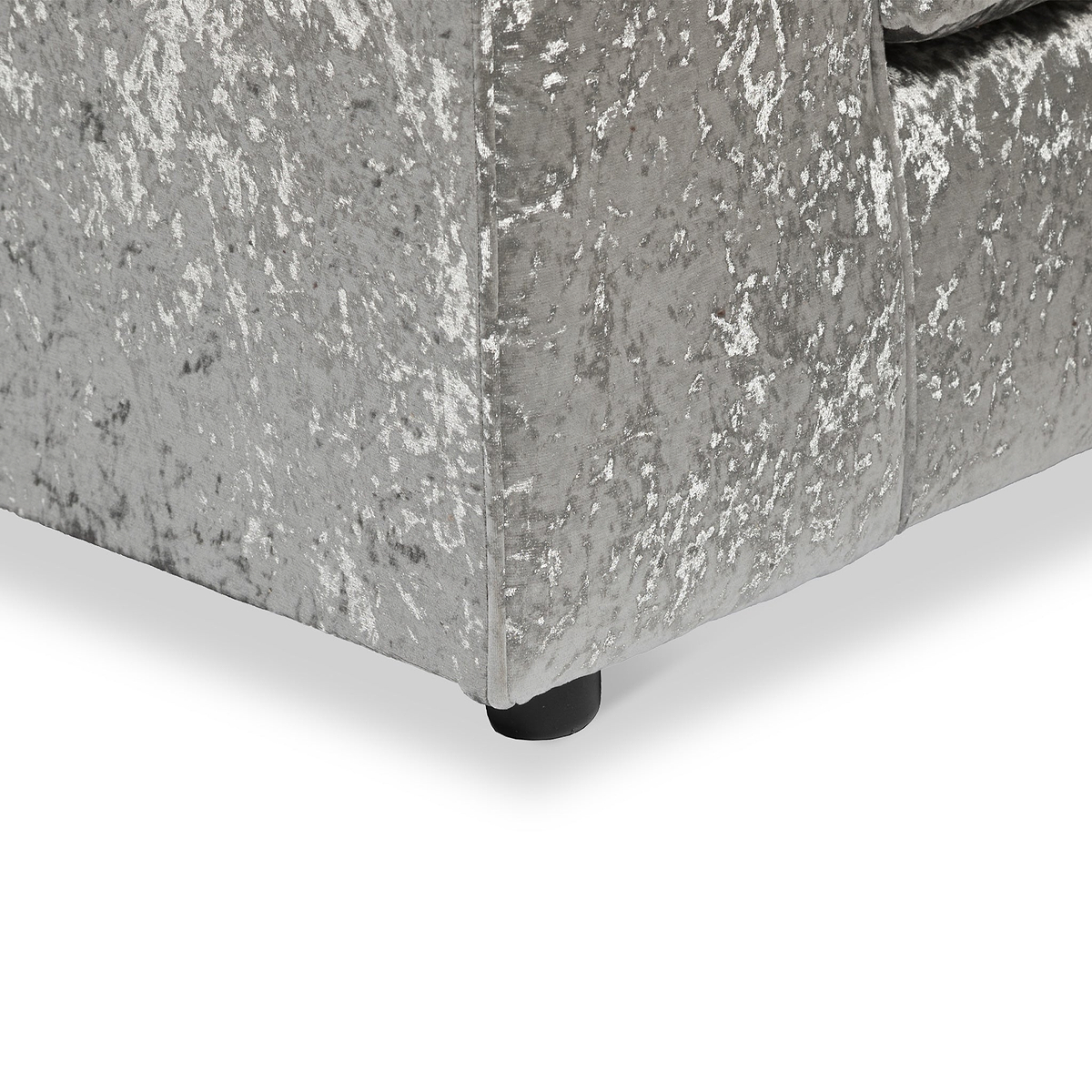 Grey upholstered bed frame with a textured fabric and a leg visible against a white background.