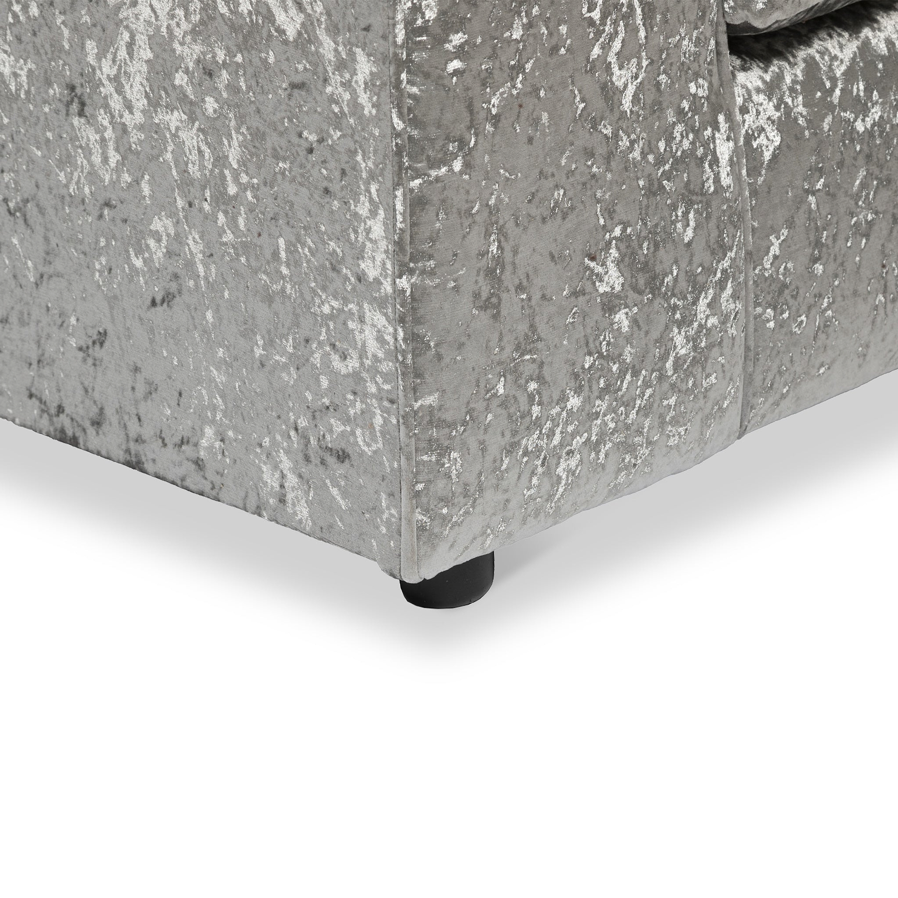 Grey upholstered bed frame with a textured fabric and a leg visible against a white background.