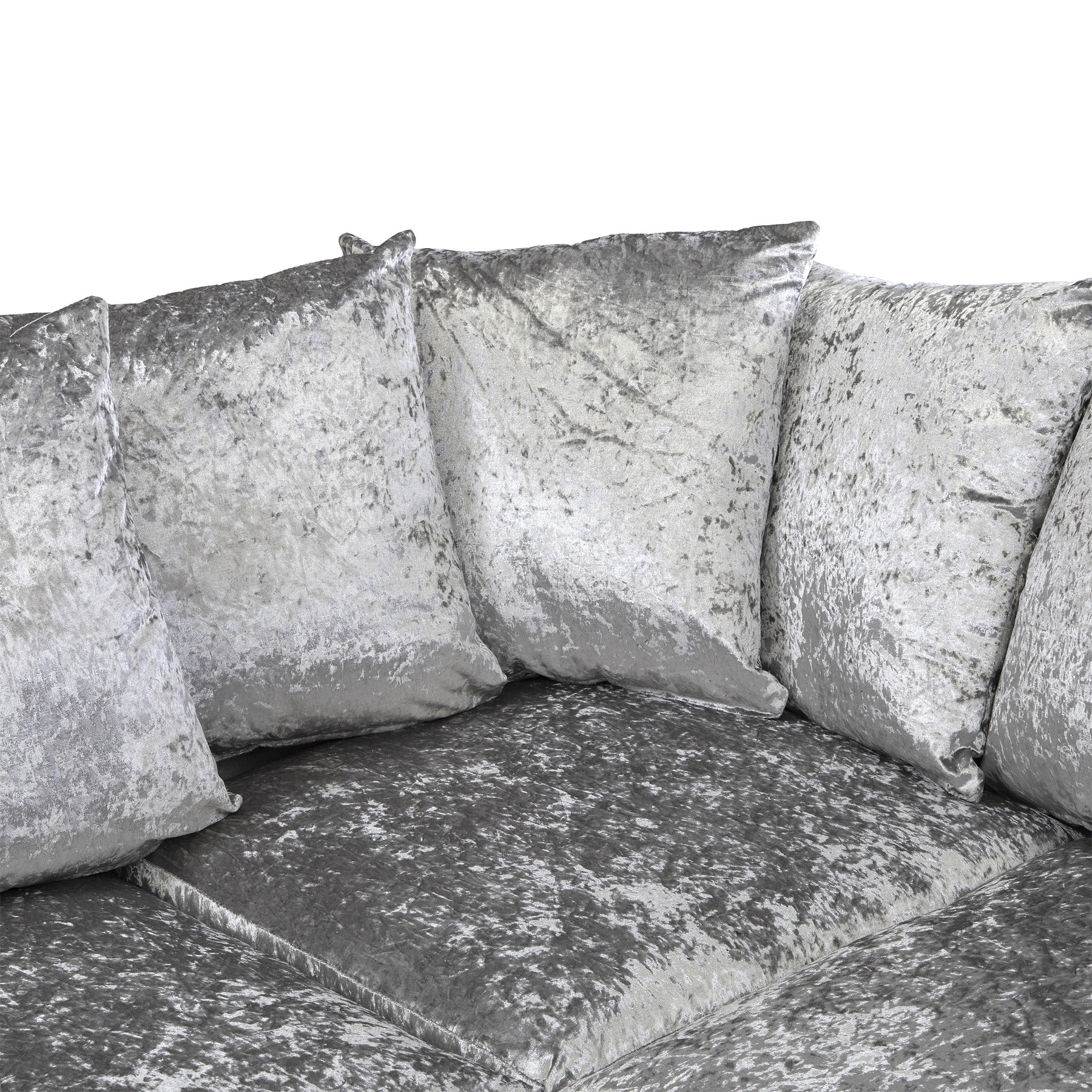 Four silver velvet cushions rest against each other on a matching couch, isolated against a white background.
