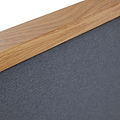 A wooden frame corner overlays a textured gray surface, possibly part of a bulletin board or artwork, with a focus on material details and junction craftsmanship.