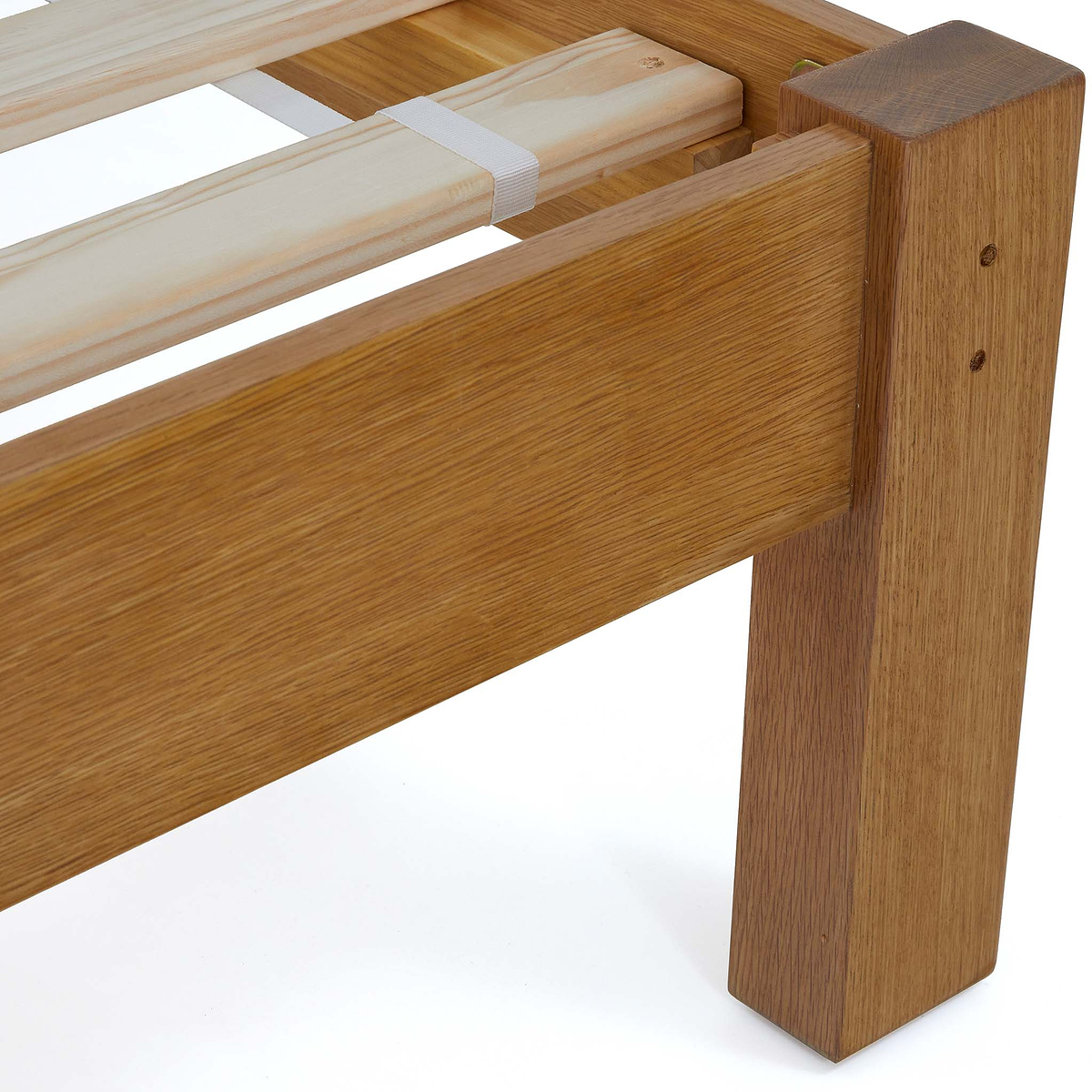 A wooden bed frame corner, with visible slats and support straps, against a white background.