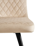 A beige upholstered chair with diamond pattern stitching on a white background.