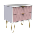 A pink and white modern chest of drawers with golden handles and angled legs, isolated on a plain background.