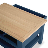 Wooden lid partially covering a blue box, suggesting a storage function, with a simplistic modern design.