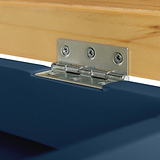 A metal hinge connects a wooden piece to a blue surface, allowing pivoting motion. This is a close-up of the hardware component in a simple indoor setting.
