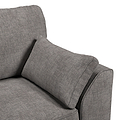 A grey fabric sofa with a cushion rests against an armrest, set against a white background.