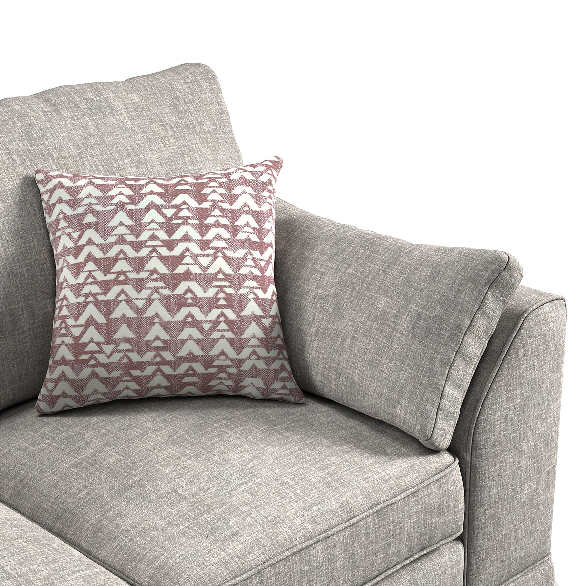 A patterned pillow rests on a gray fabric sofa, suggesting a comfortable, domestic setting.