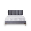 A grey upholstered bed with a tufted headboard is stationary against a white background. A plush white mattress sits atop the frame.