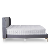 A single bed with mattress, featuring a grey upholstered headboard, rests stationary against a plain white background.