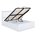 A white storage bed with its base lifted to reveal an empty space underneath, against a plain background. The frame includes wooden slats and a hydraulic lifting mechanism.
