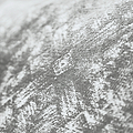 A textured fabric with a mottled pattern, close-up shot creating an abstract, tactile surface. The context is indeterminate due to the close focus. No text present.