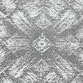 A textured pattern with a symmetrical, ornate central motif contrasting with the surrounding rough surface.