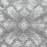 A textured pattern with a symmetrical, ornate central motif contrasting with the surrounding rough surface.
