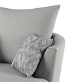 A grey fabric armchair with a patterned cushion; the focus is on the chair's soft textures and comfort. No text is present.