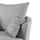 A grey fabric armchair with a patterned cushion; the focus is on the chair's soft textures and comfort. No text is present.