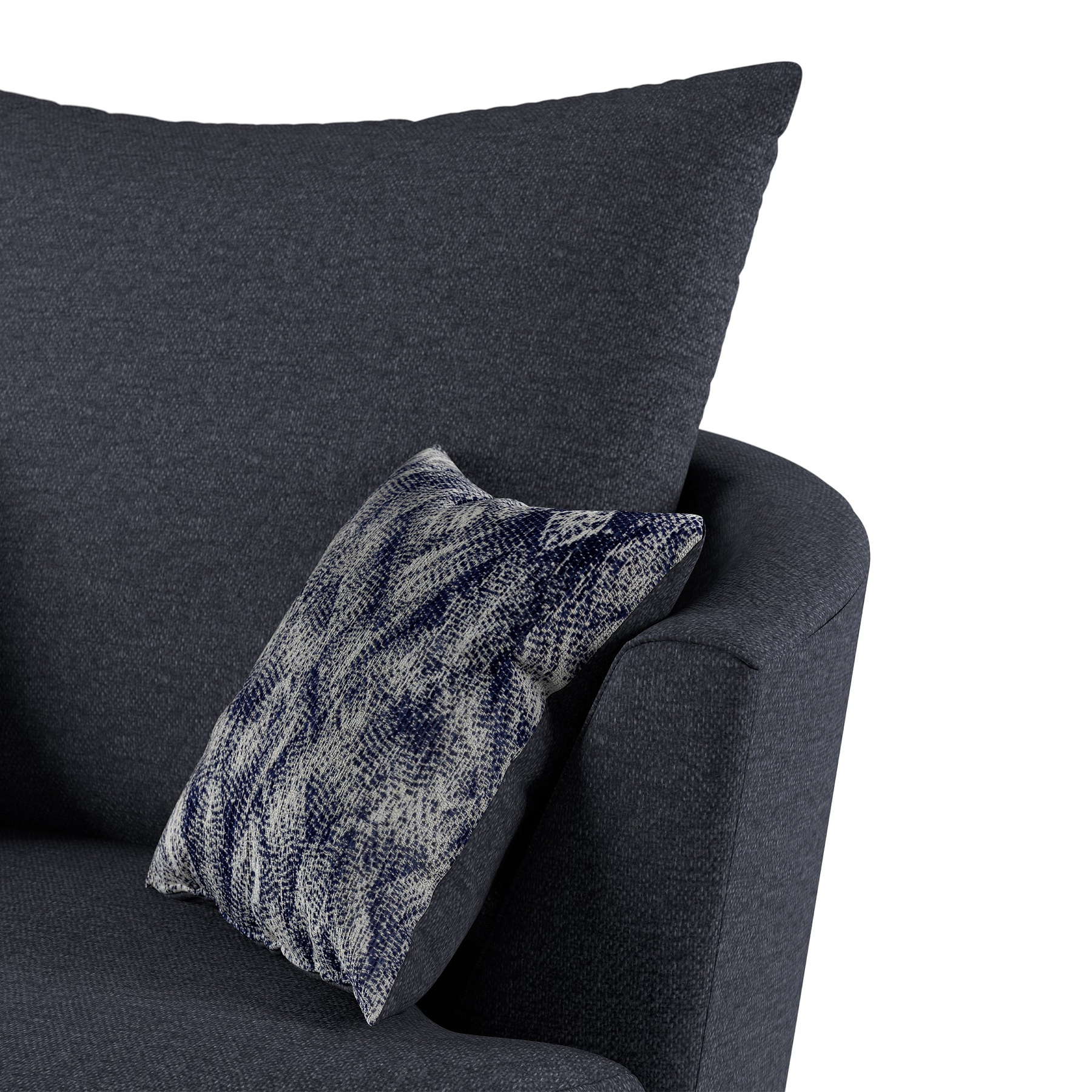 A dark gray upholstered armchair with a patterned blue and white throw pillow angled casually on the seat. The background is a neutral light gray.