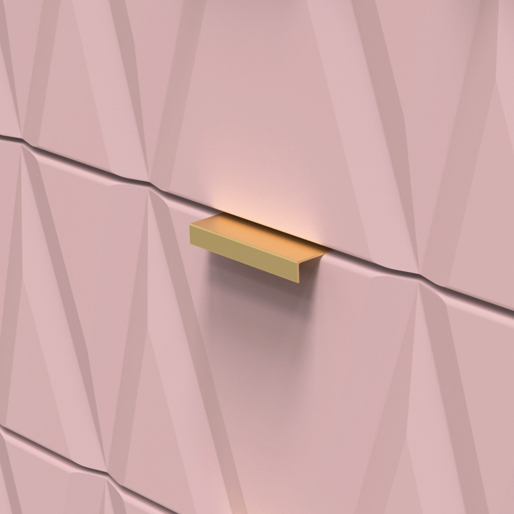 Golden rectangular drawer handle on a pink faceted wall, light subtly accentuating its color and shape.