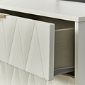 A white drawer with a geometric pattern is partially open, revealing a grey fabric interior with an item inside, against a white background.