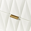 A gold bar-shaped object protrudes from a white, geometric, textured wall, creating a shadow beneath it.