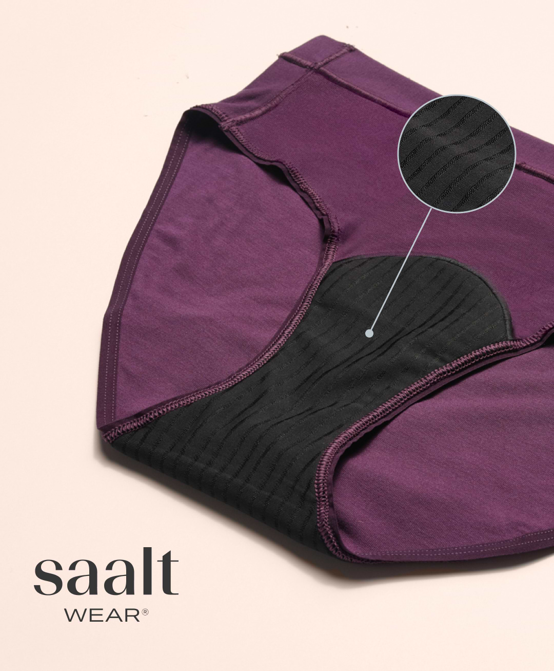 Purple period underwear with black absorbent lining and fabric texture close-up detail.