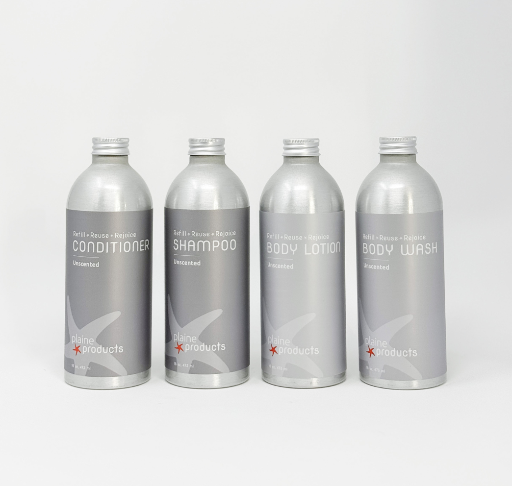 Four silver refill bottles labeled conditioner, shampoo, body lotion, and body wash on white background.