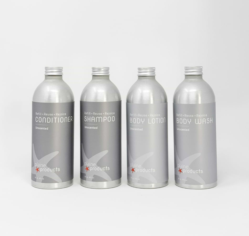 Four silver refill bottles labeled conditioner, shampoo, body lotion, and body wash on white background.