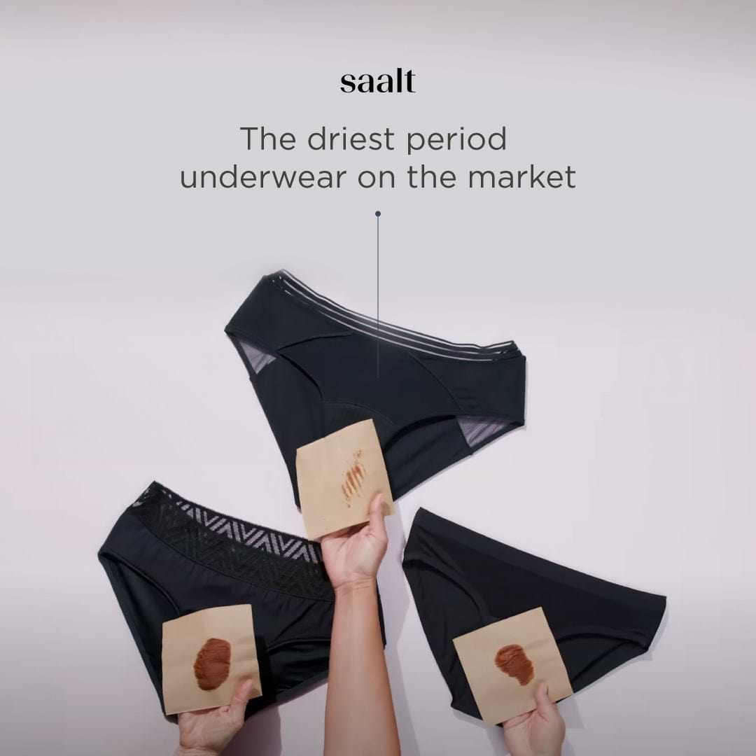 Ad showing black period underwear with absorbency demo cards and text claiming dryness performance.