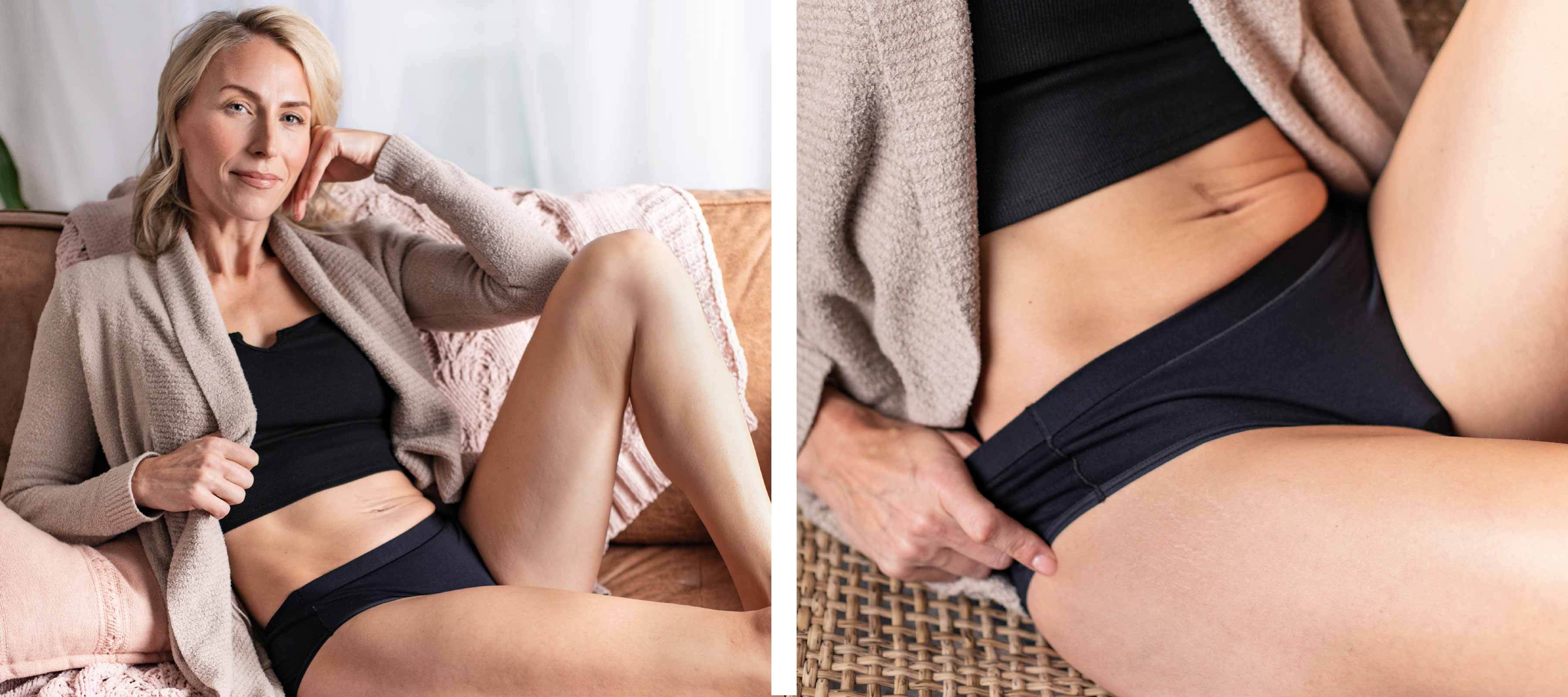 Woman lounging indoors wearing black seamless period underwear and matching bra with cozy cardigan