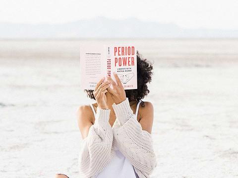 Woman reading about periods and TSS