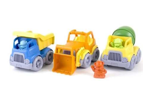 Three colorful toy construction trucks with small toy figures on a light gray background.