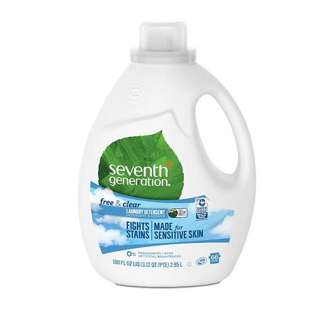 Bottle of Seventh Generation Free & Clear laundry detergent for sensitive skin on gray background.