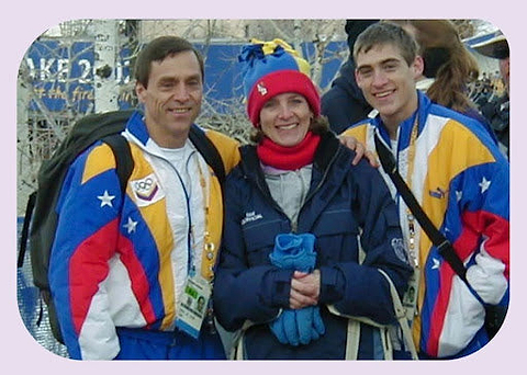 A proud family shares a special moment together, dressed in vibrant team jackets during a winter event.