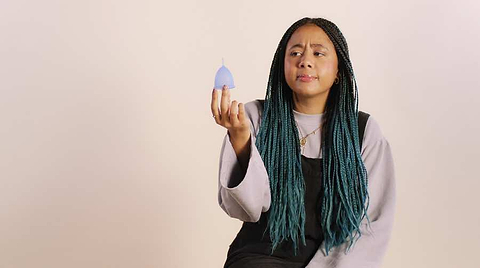 Woman holding a blue cup