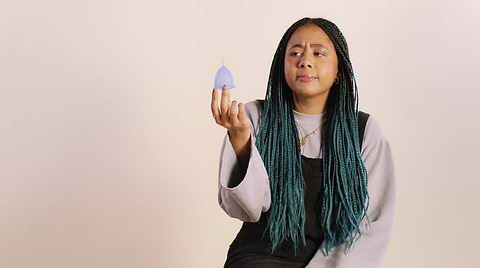 Woman holding a blue cup