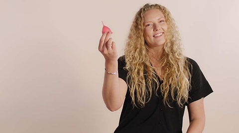 Woman holding a pink Saalt cup
