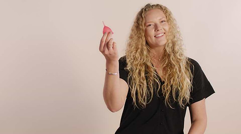 Woman holding a pink Saalt cup