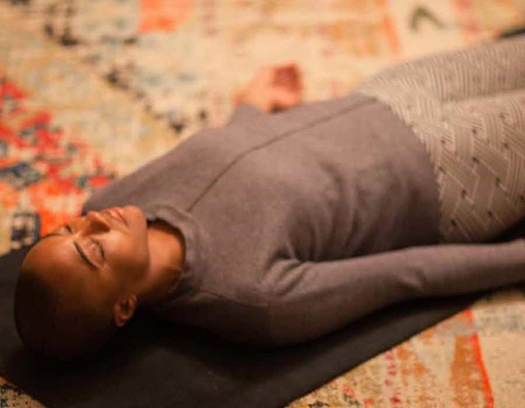 Person in corpse yoga pose