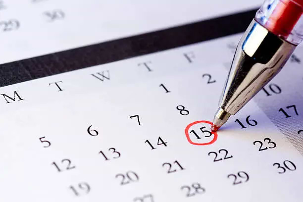 Calendar Showing A Pen Circling A Date To Track Period