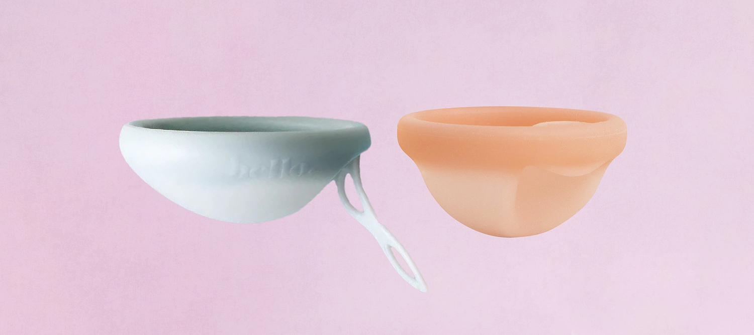 Two menstrual discs in white and beige displayed side by side on a pink background.