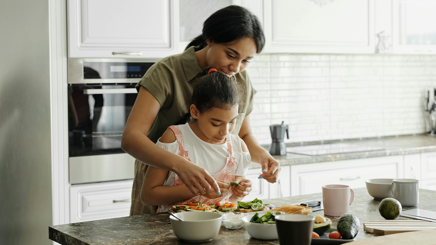 Mother And Child Prepping Vegetables And Toast