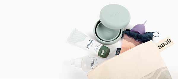 Saalt menstrual care essentials including cup, cleanser, sanitizer, storage pouch, and travel case.