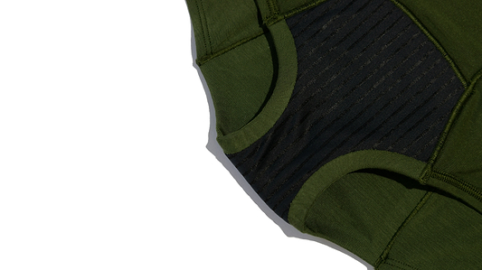 Close-up of green and black period underwear with textured fabric details.