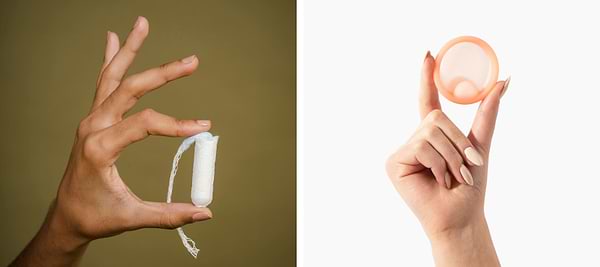Hand holding tampon beside reusable menstrual disc on split neutral background