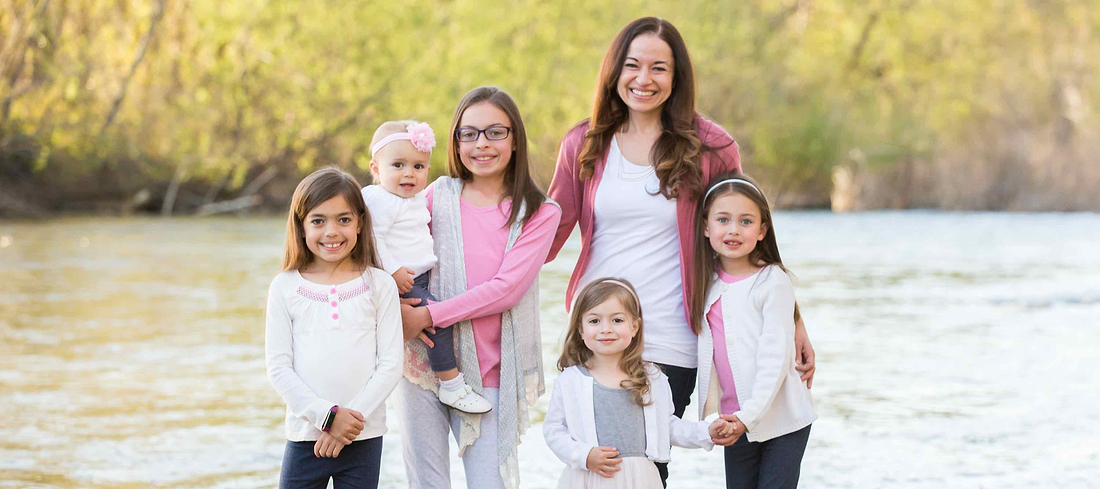 A joyful family shares a peaceful riverside moment, celebrating togetherness, love, and everyday connection.