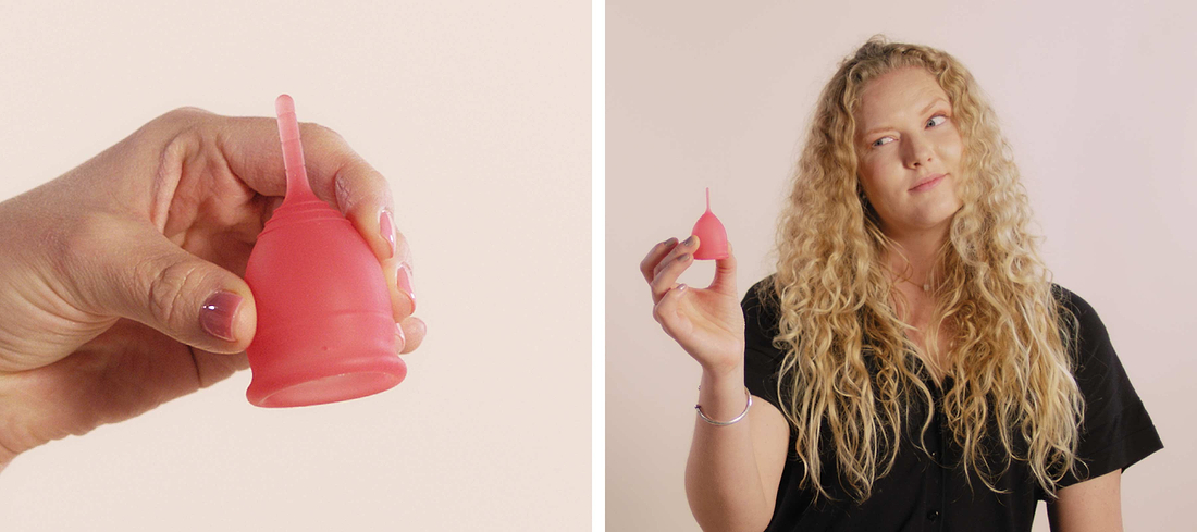 Close-up and lifestyle shot of a woman holding a pink menstrual cup against a soft neutral background.