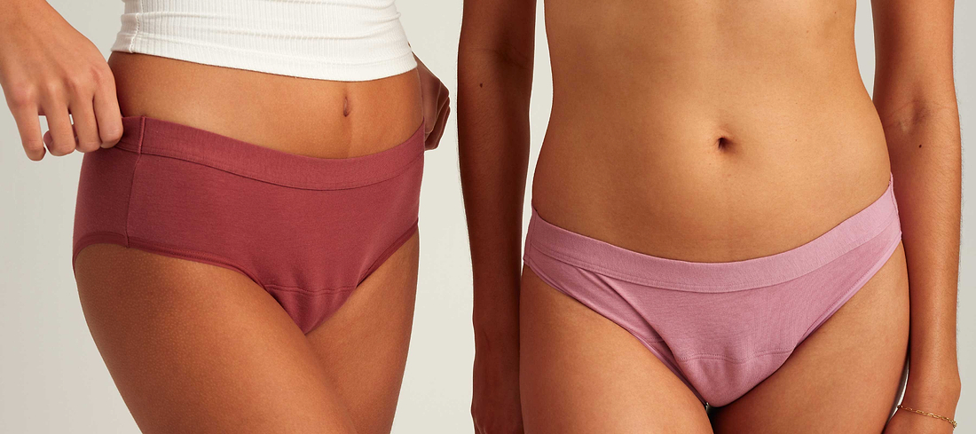 Close-up of two people modeling mauve and pink period underwear against a neutral background.