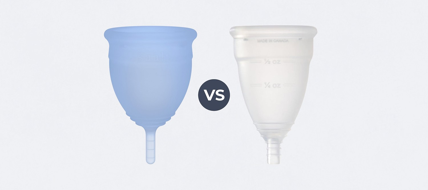 Blue menstrual cup beside clear menstrual cup with “VS” between them on a light background.