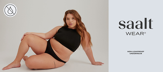 Model in black underwear and crop top beside “saalt wear” logo and non-leakproof underwear text.